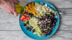 flat lay photography of man making vegetable and fruit salad