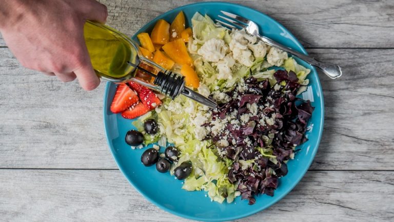 flat lay photography of man making vegetable and fruit salad